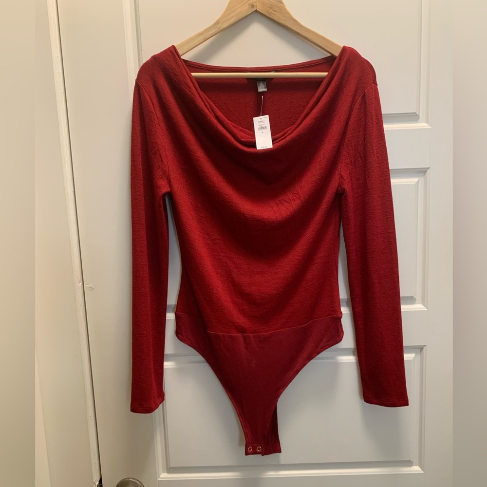 Red knit bodysuit, long sleeve with swoop neckline.